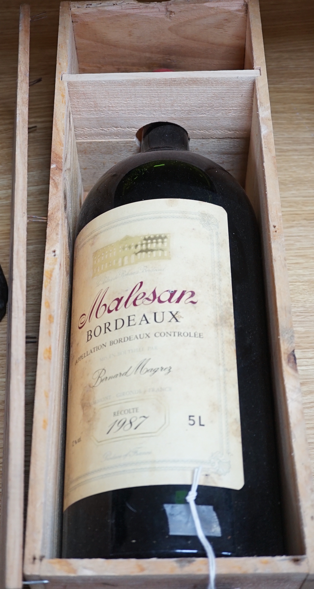 A 5 litre bottle of 1987 Malesan Bordeaux red wine in a wooden case, 50cm